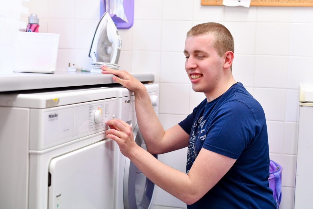 Student independently using washing machine