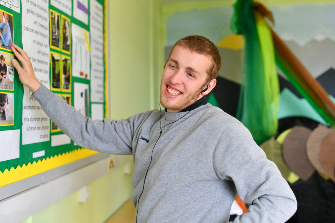 Student DJ using tactile wall displays in the colourful Malvern Room