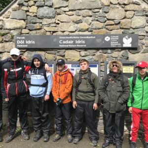 Students posing for a photo at the foot of Cadair Idris before they start the climb