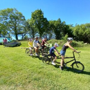 Tandem riding across the camping field