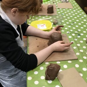 Female student also having a go at making a plant pot shape