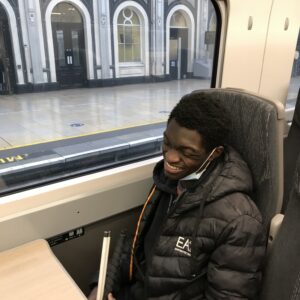 Eben smiling on the train, sat by the window!