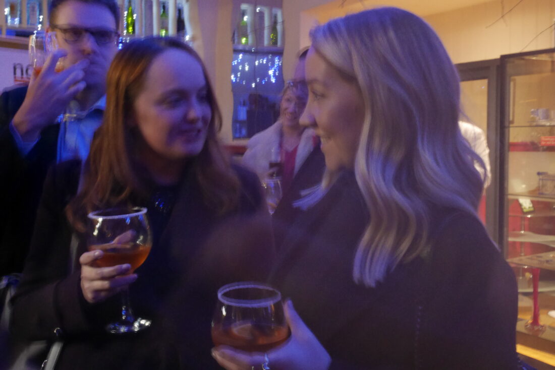 Image of two people at the bar enjoying a welcome drink