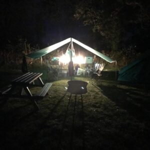 A view of the campsite seating area undercover in the dark