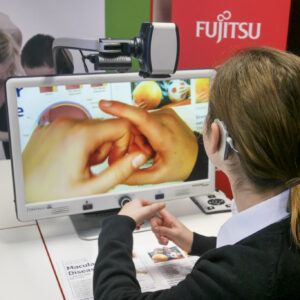 Female student is using the DaVinci Pro machine, which magnifies onto a larger screen