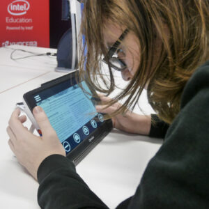 Close up of male student using the Optelec Compact tablet