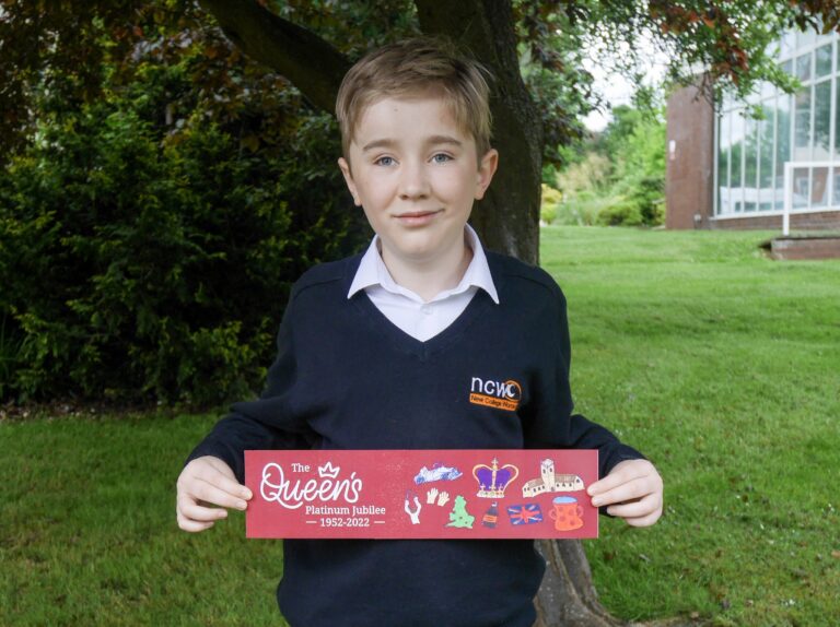 Jamie stood holding his winning banner