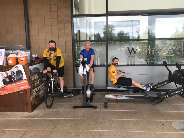 image of three of the partners on exercise machines outside of the store