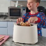 Student is taking toast out of the toaster