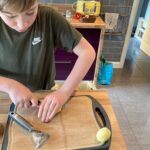 Student is cutting potatoes using the bridge hold