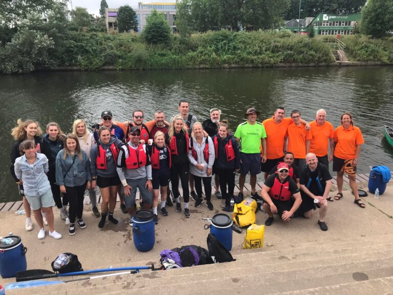 group photo of the canoeists and the river guides at the end of the trek