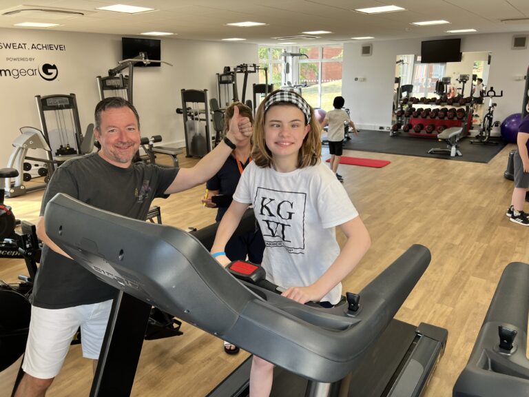 Lily Grace smiling whilst on the treadmill, and a thumbs up from Mr Stark