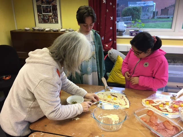 Young people on Revision Course are making their own pizzas in one of the residential houses