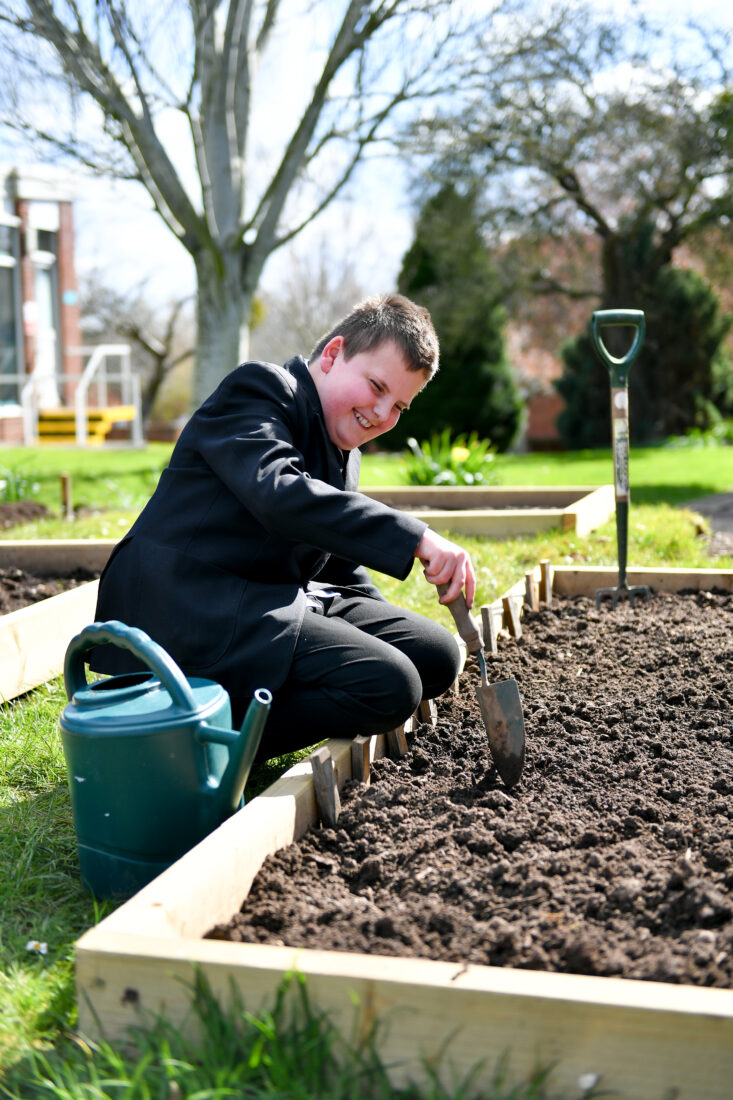 Image of Lawson digging using a trowel