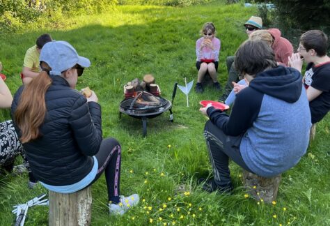 image of students sat around the camp fire