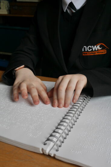 image of hands reading Braille