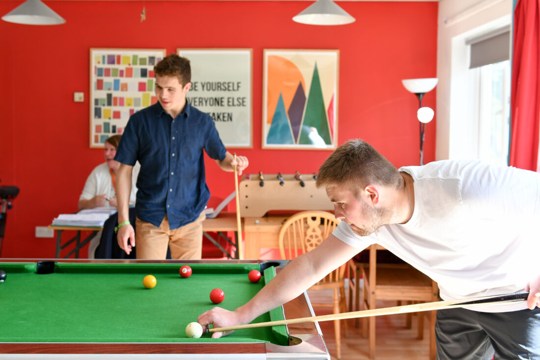 image of two students playing pool in the Hostel