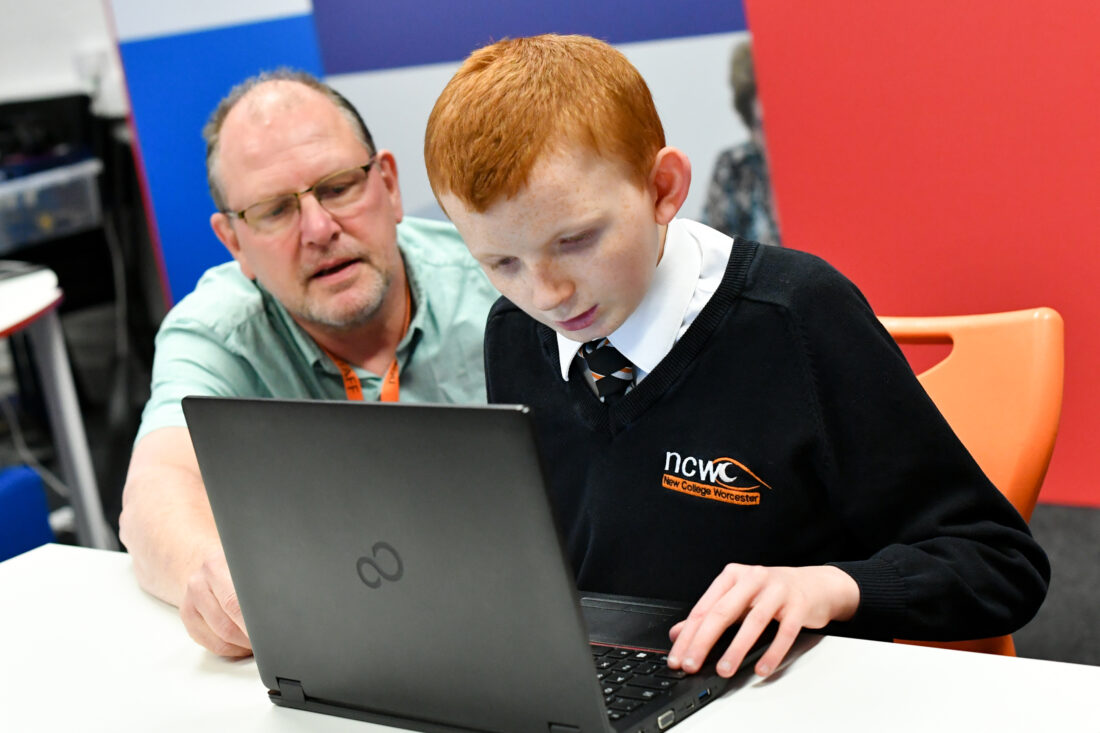 image of a student and teacher working together on a laptop