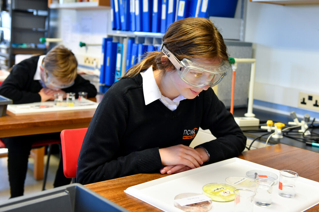 image of a student wearing safety googles during a a science lesson