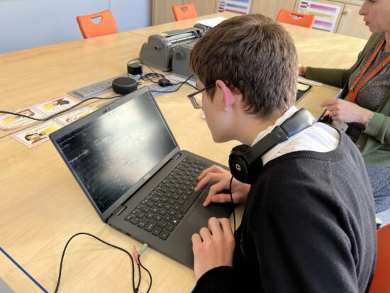 image of a student working on their laptop