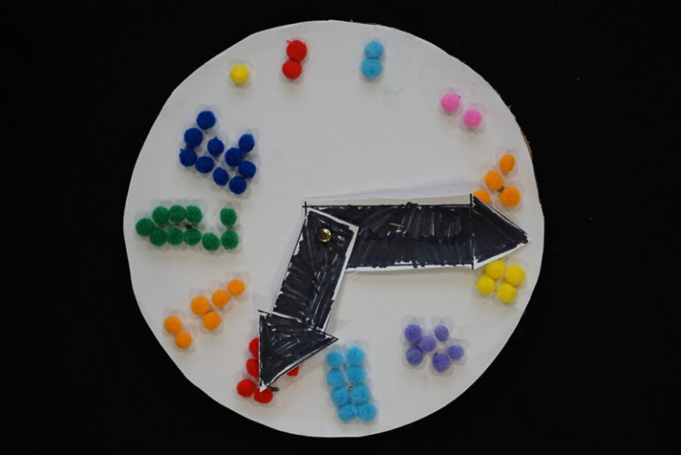 Image of clock with the time made out of clay beads for the Braille numbers