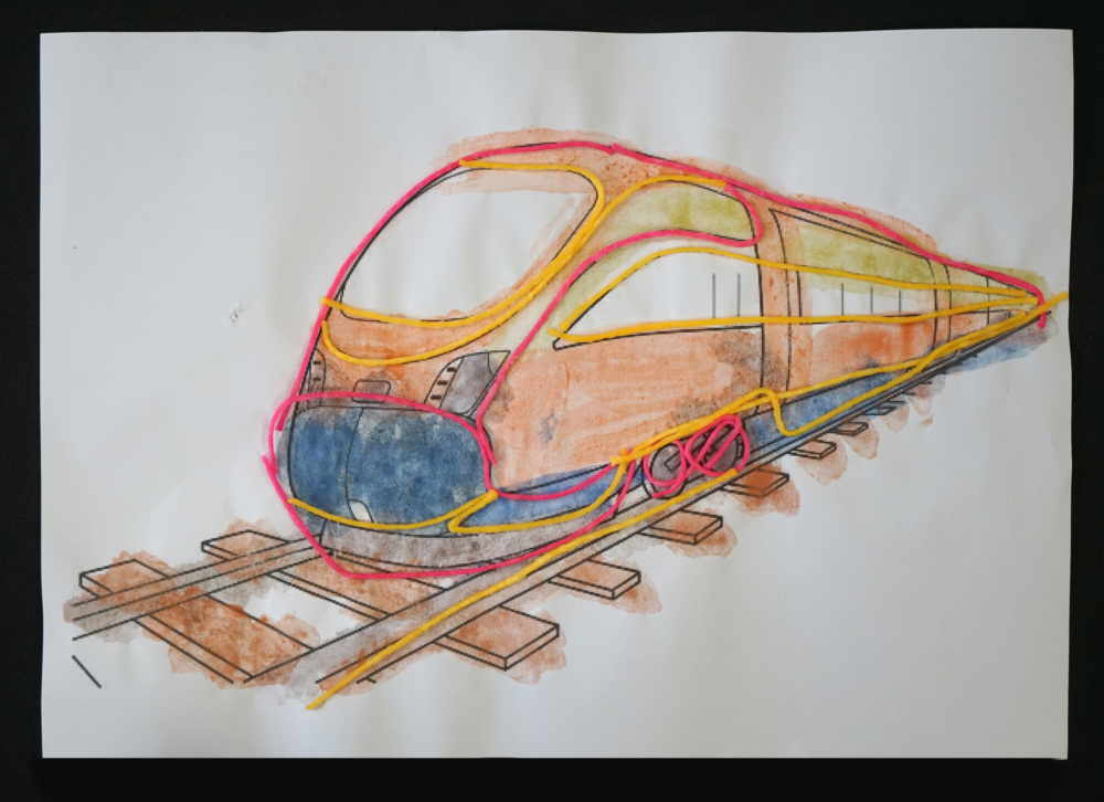 image of a train on tracks, wiki sticks have been used to raise the image