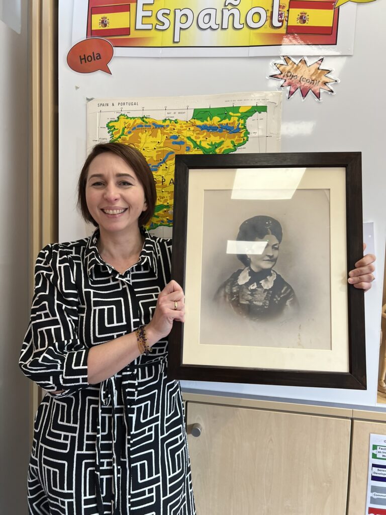 Mrs Molina holding the portrait.