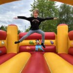 image of a child mid air jumping on a bouncy castle