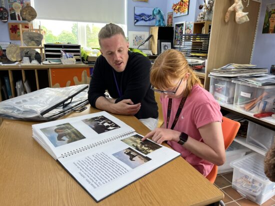 image of Carys and Jake looking at her portfolio