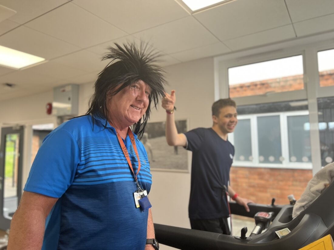 image of Pete wearing a wig and Thomas laughing and pointing at him