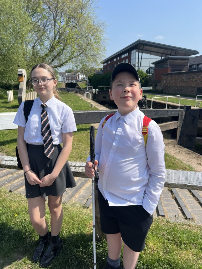 Photo of Bella and Ed on a sunny day by the canal basin smiling