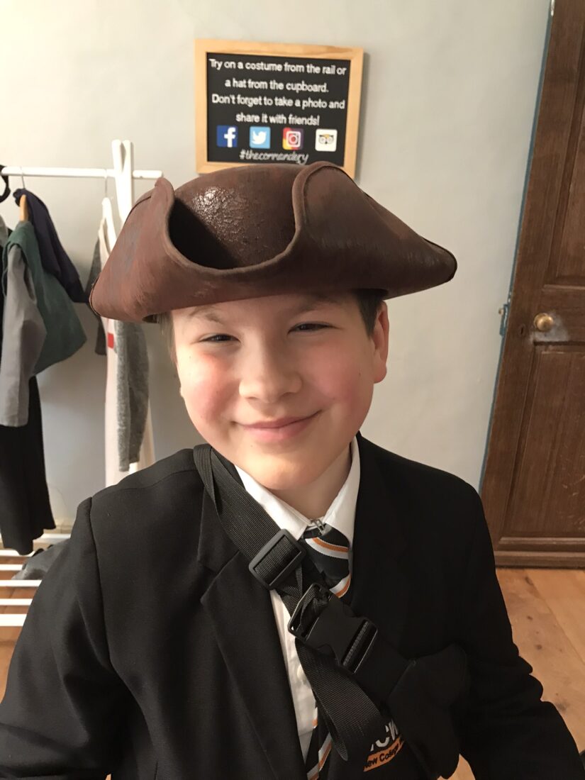 Photo of Ed wearing a period brown hat and smiling