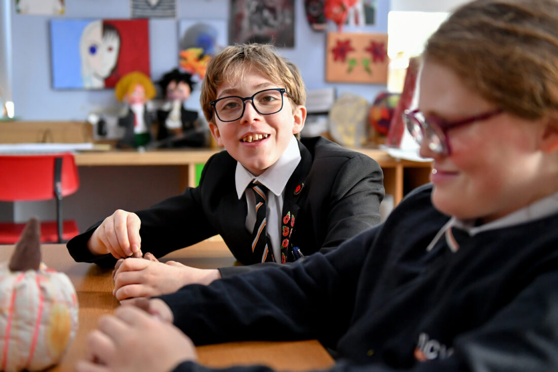 Photo of two students during an art lesson smiling