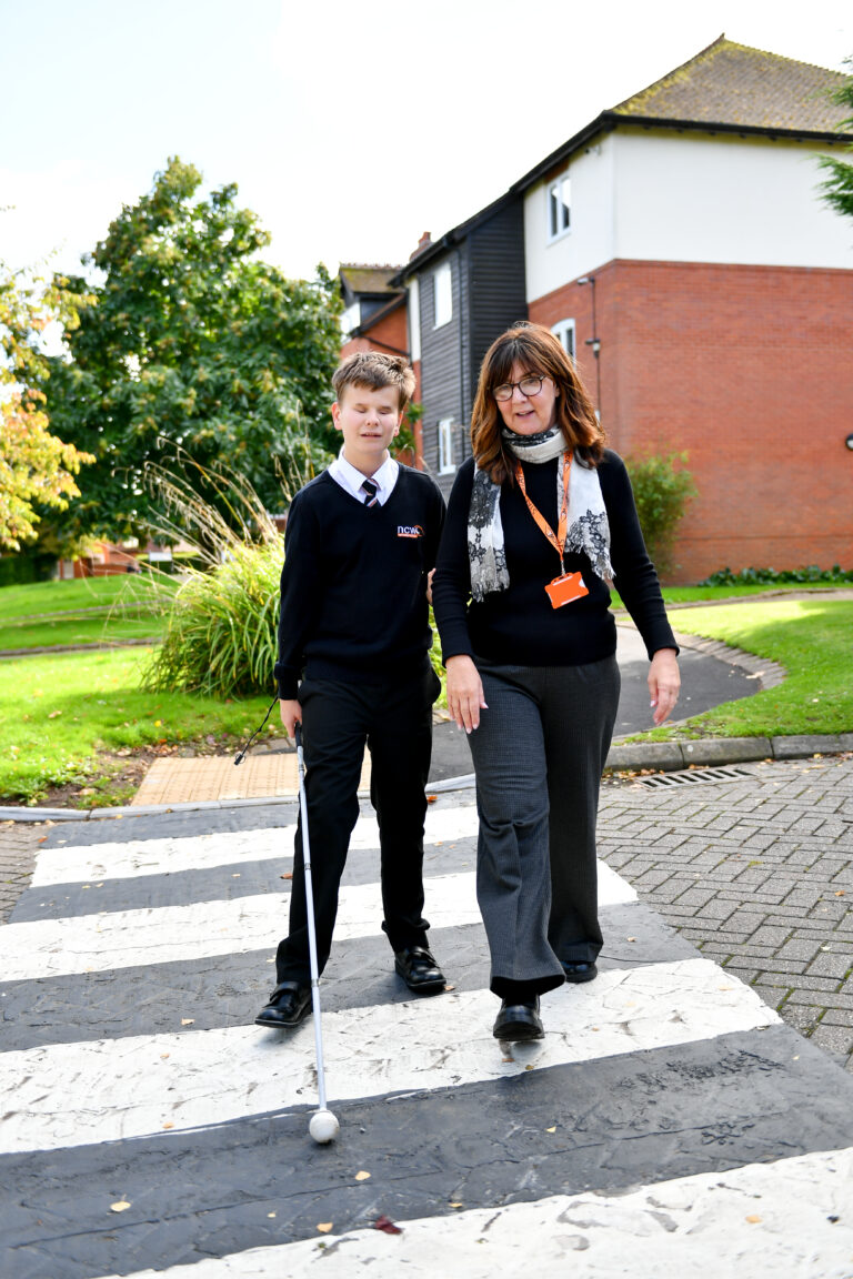 Photo of a student and staff member on a mobility lesson in the grounds of NCW