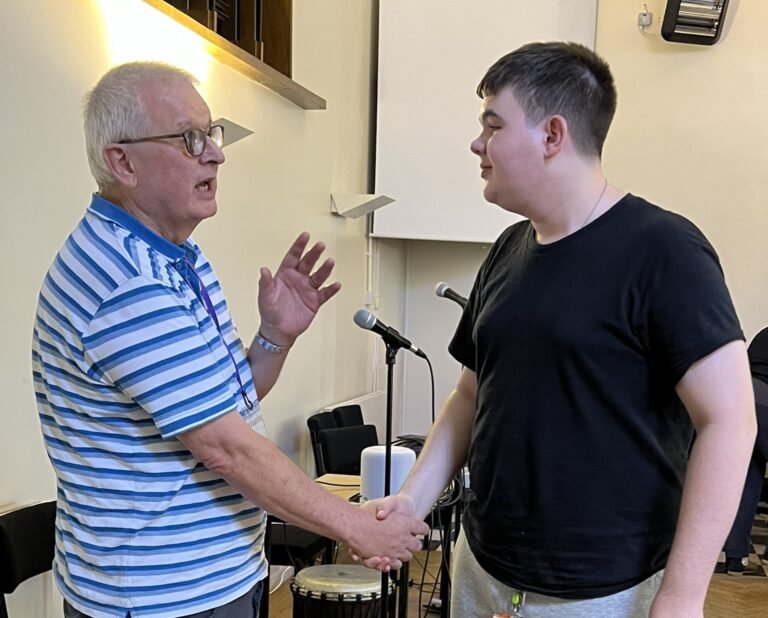Photo of Anthony Clements and Jake shaking hands