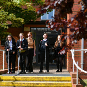 A group of six students on the steps of the LRC at NCW