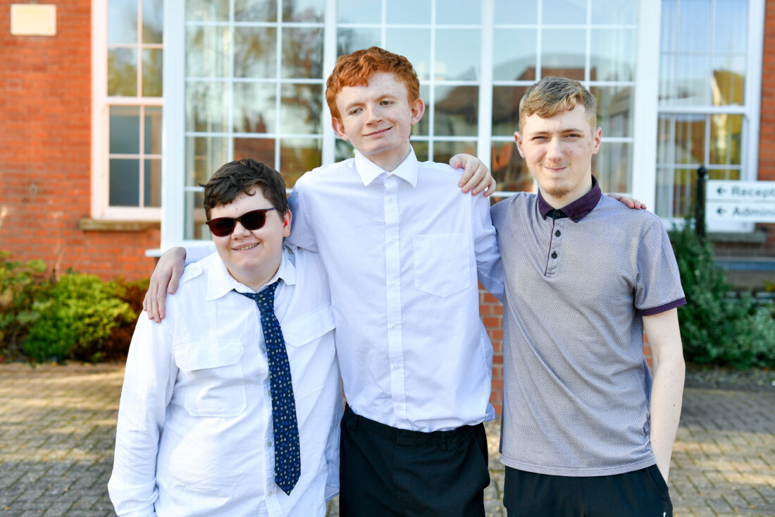 Photo of three students smiling