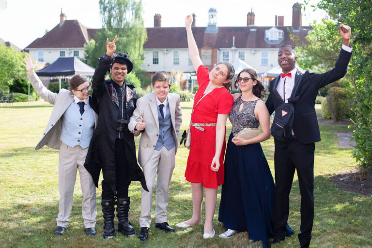 students posing for a photo on the lawn