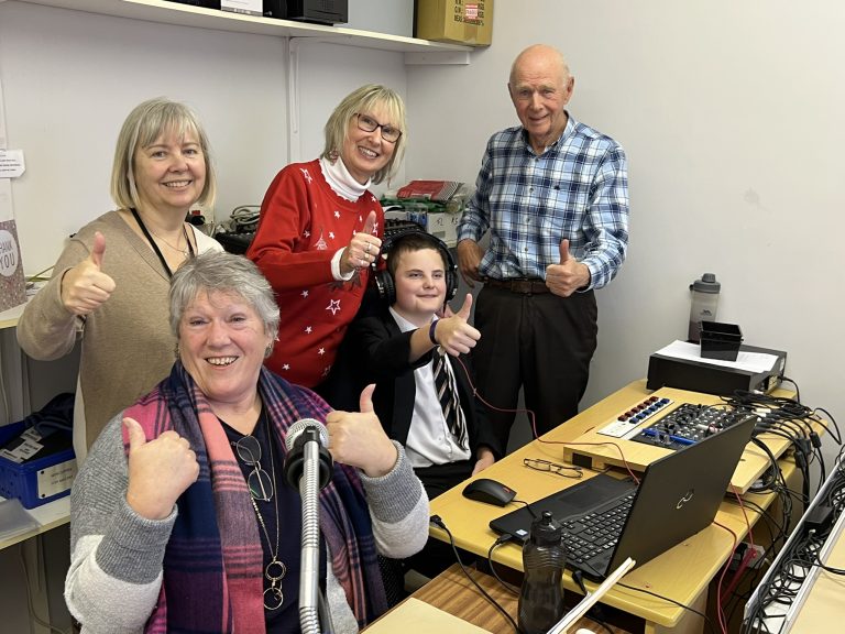 Photo of Lawson and the Talking Talking News staff smiling at the camera
