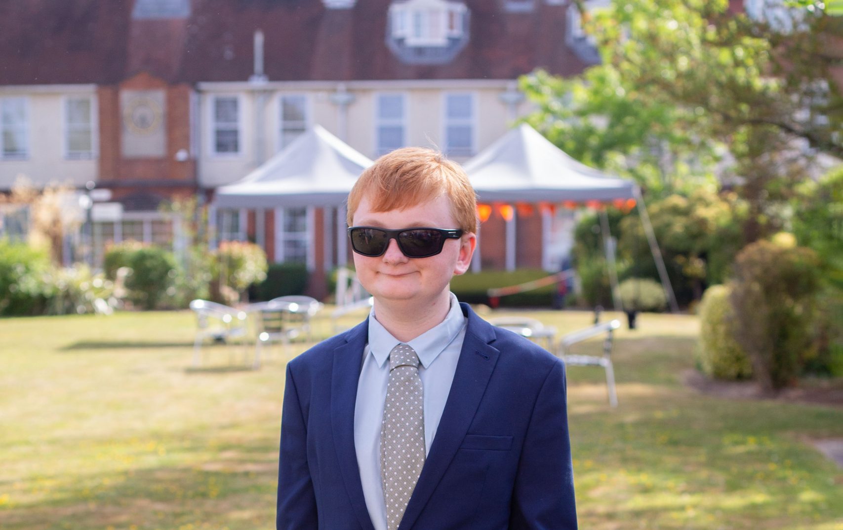 Photo of Finley smiling at the camera on the lawn at NCW