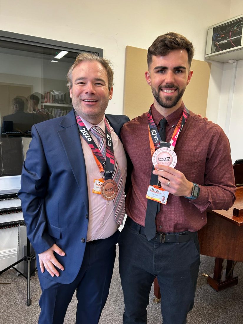 Mr Painter and Mr Styles smiling whilst holding their medals