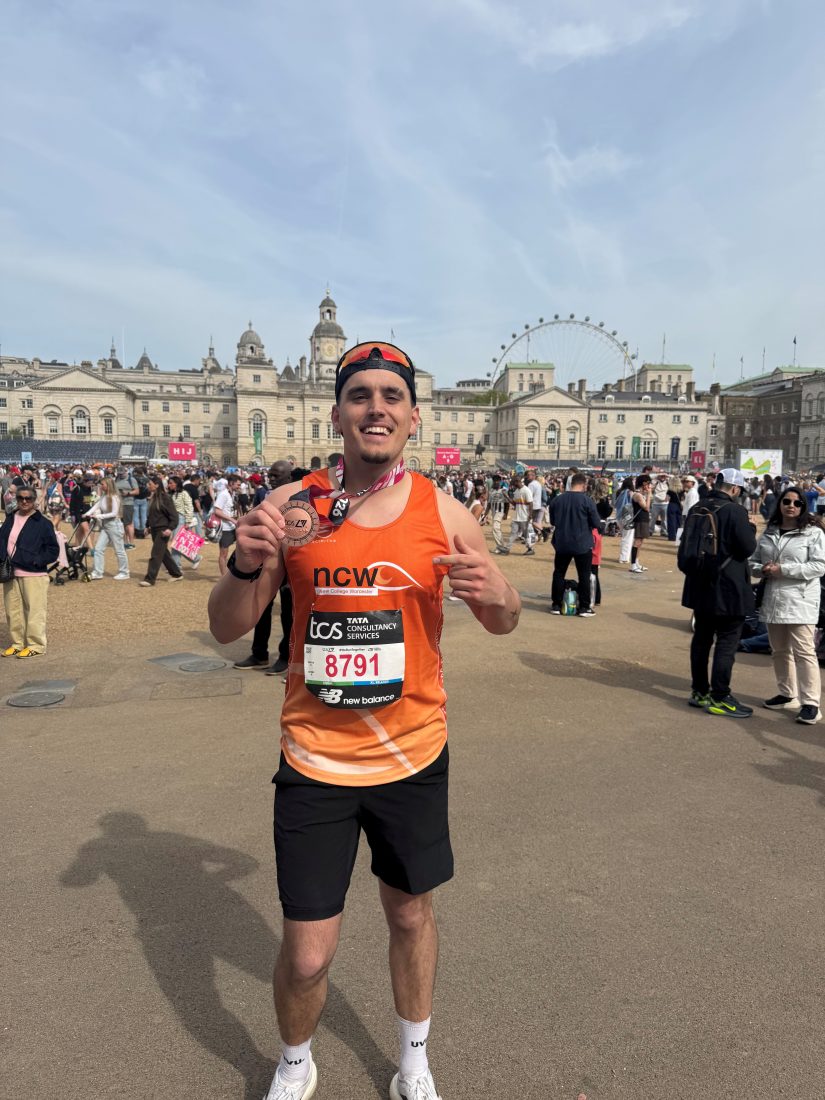 Dan post race smiling holding his medal