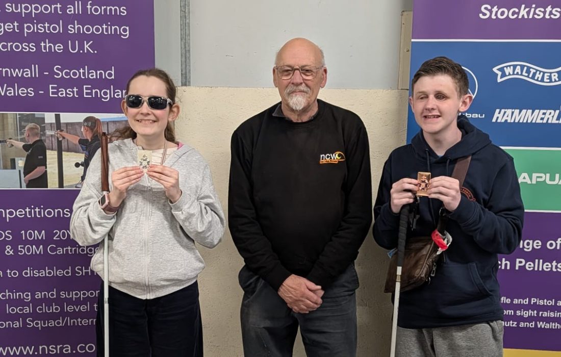 Paul, Ellie and Len smiling for a photo at the venue