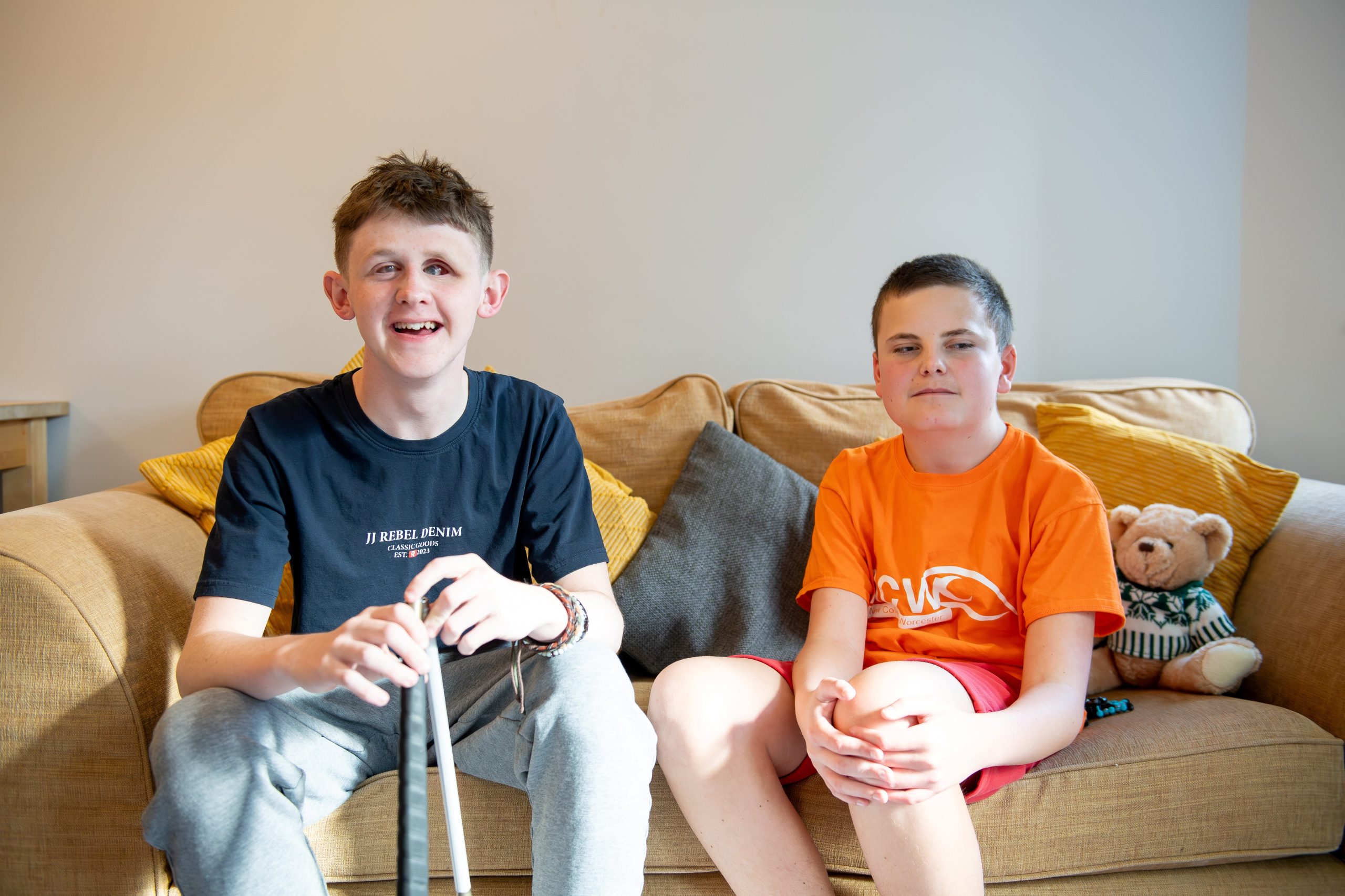 Students Lawson and Len sitting on a sofa and smiling