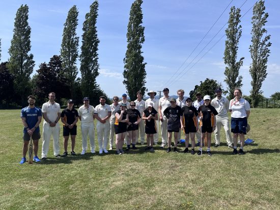 Players, staff and student smiling for a group photo