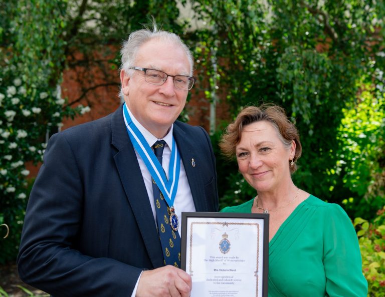 Photo of the HIgh Sheriff of Worcestershire and Victoria Ward smiling with the award