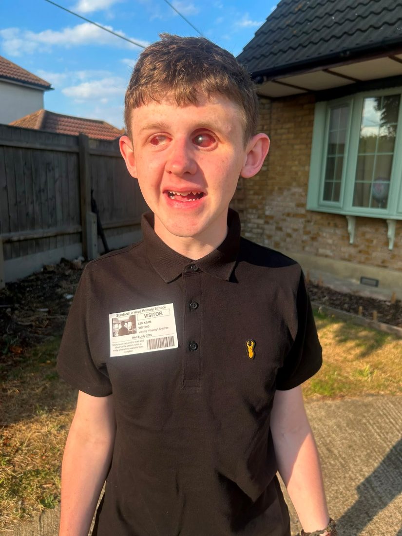 A photo of Len smiling outside of the school